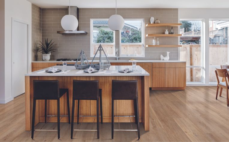 luxury vinyl in kitchen with wood details and subway tile backsplash